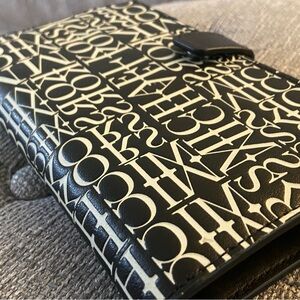 Michael Kors wallet w strap, black and white,two zipper pockets like brand new